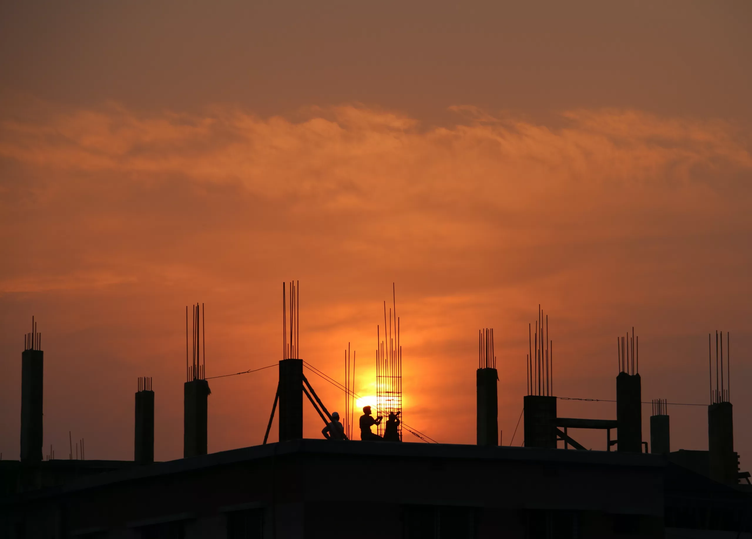 https://www.pexels.com/photo/silhouette-of-men-in-construction-site-during-sunset-176342/
